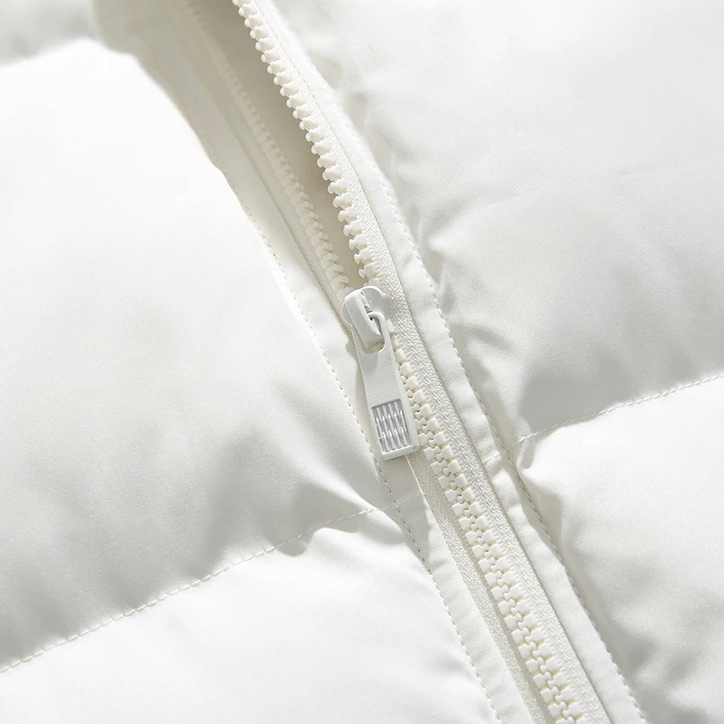 Close-up of white zipper on men's puffer jacket, showcasing sleek patchwork detailing and broadcloth fabric for winter warmth.